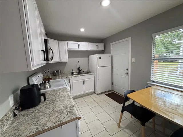 a kitchen with sink cabinets and window