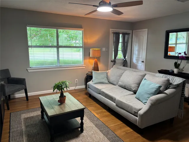 a living room with furniture and a potted plant