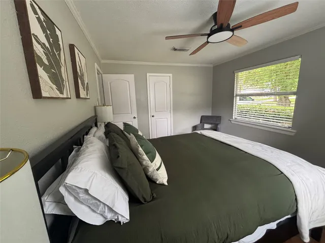 a bed sitting in a bedroom next to a window