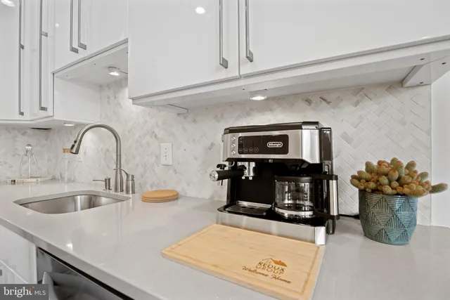a kitchen with a sink and a stove top oven