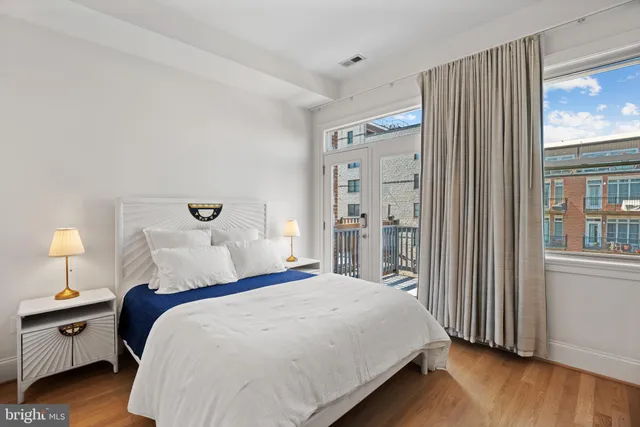 a bedroom with a bed and a night stand