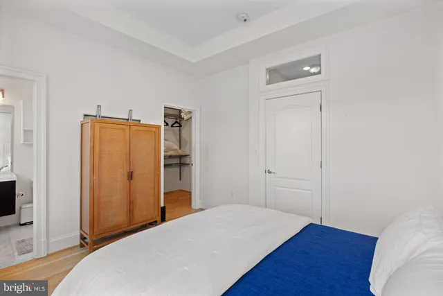 a bed room with a bed and wooden floor