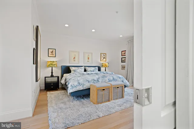 a spacious bedroom with a bed and a cabinets