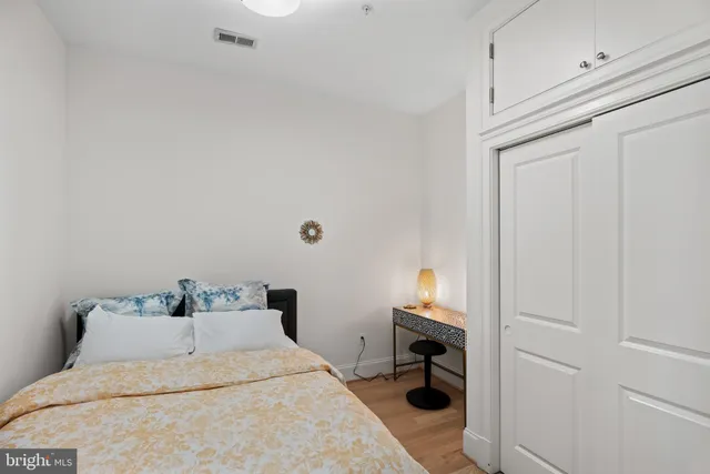 a bedroom with a bed and a lamp