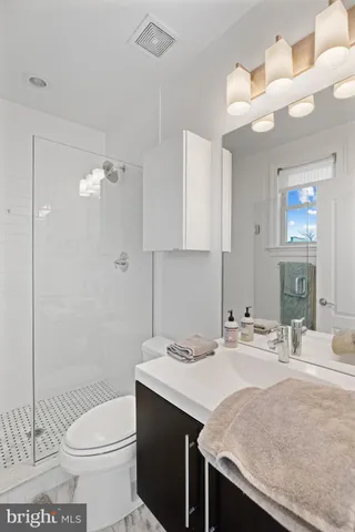 a bathroom with a sink toilet and shower