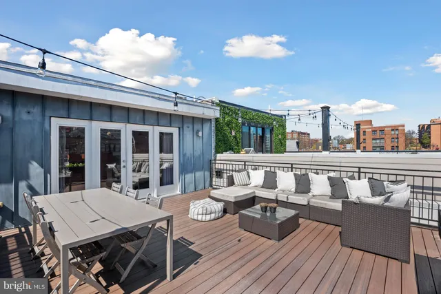 a view of a balcony with chairs and wooden floor
