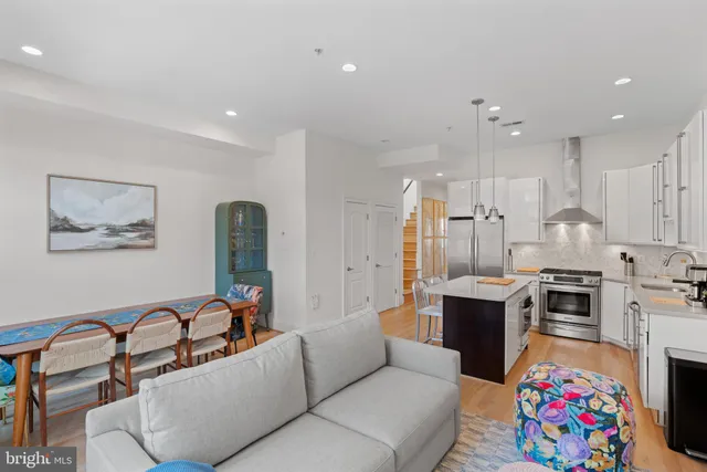 a living room with furniture a flat screen tv and a dresser