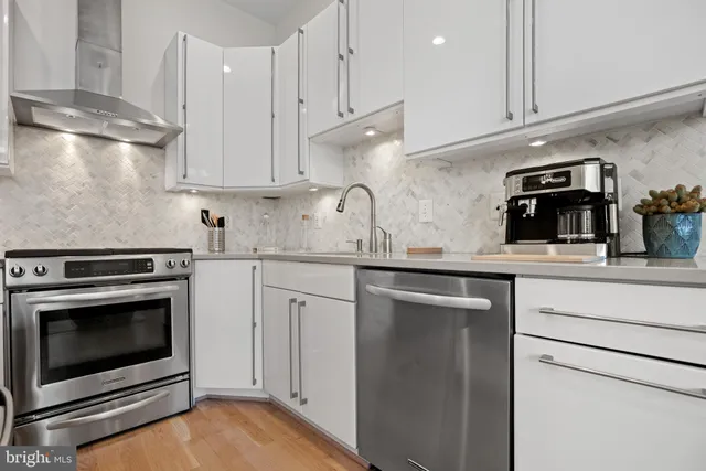 a kitchen with granite countertop cabinets stainless steel appliances and a counter space