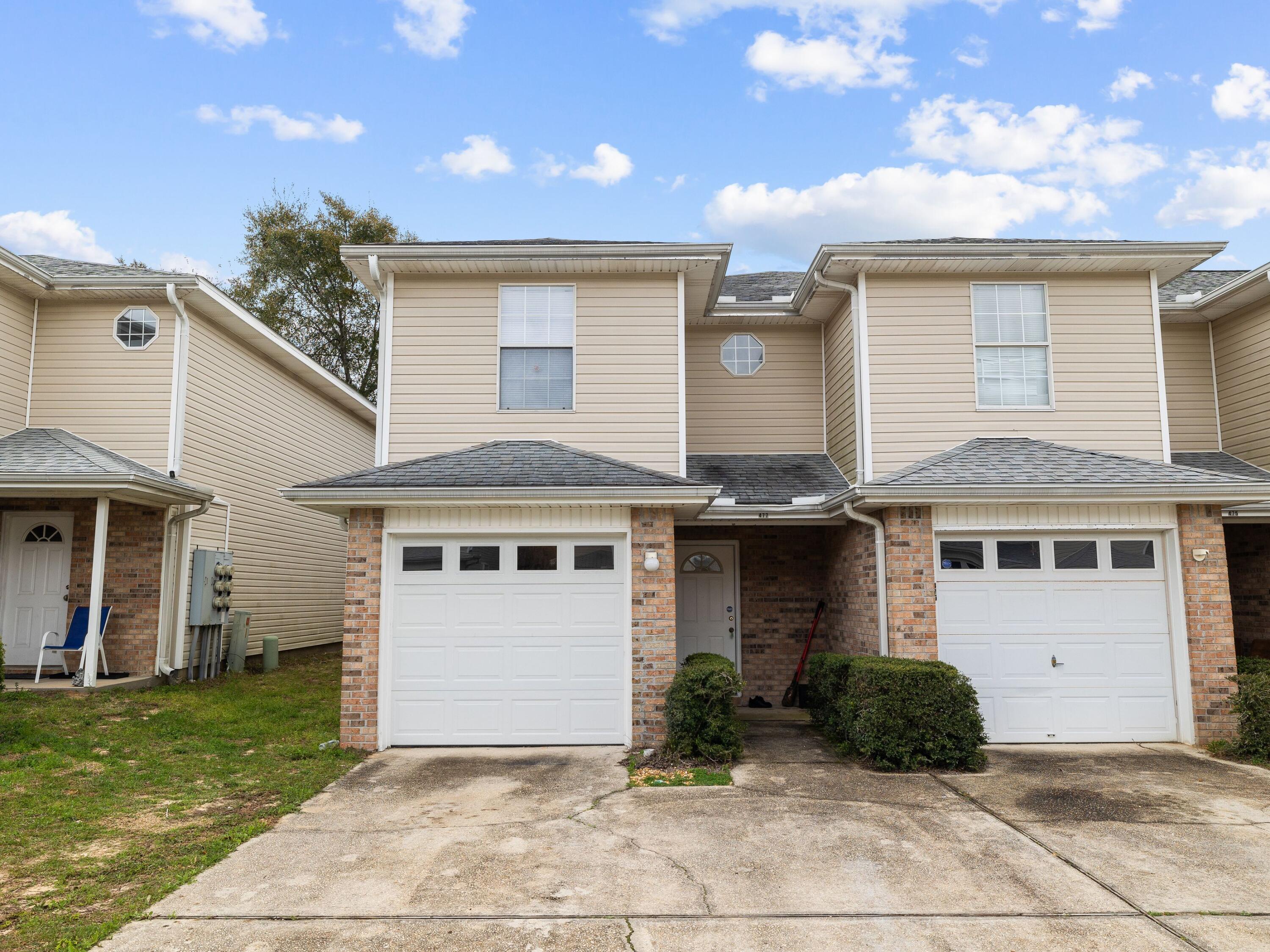 477 Keystone Road Mary Esther, FL 32569 - Photo 1 of 19 a front view of a house with garden