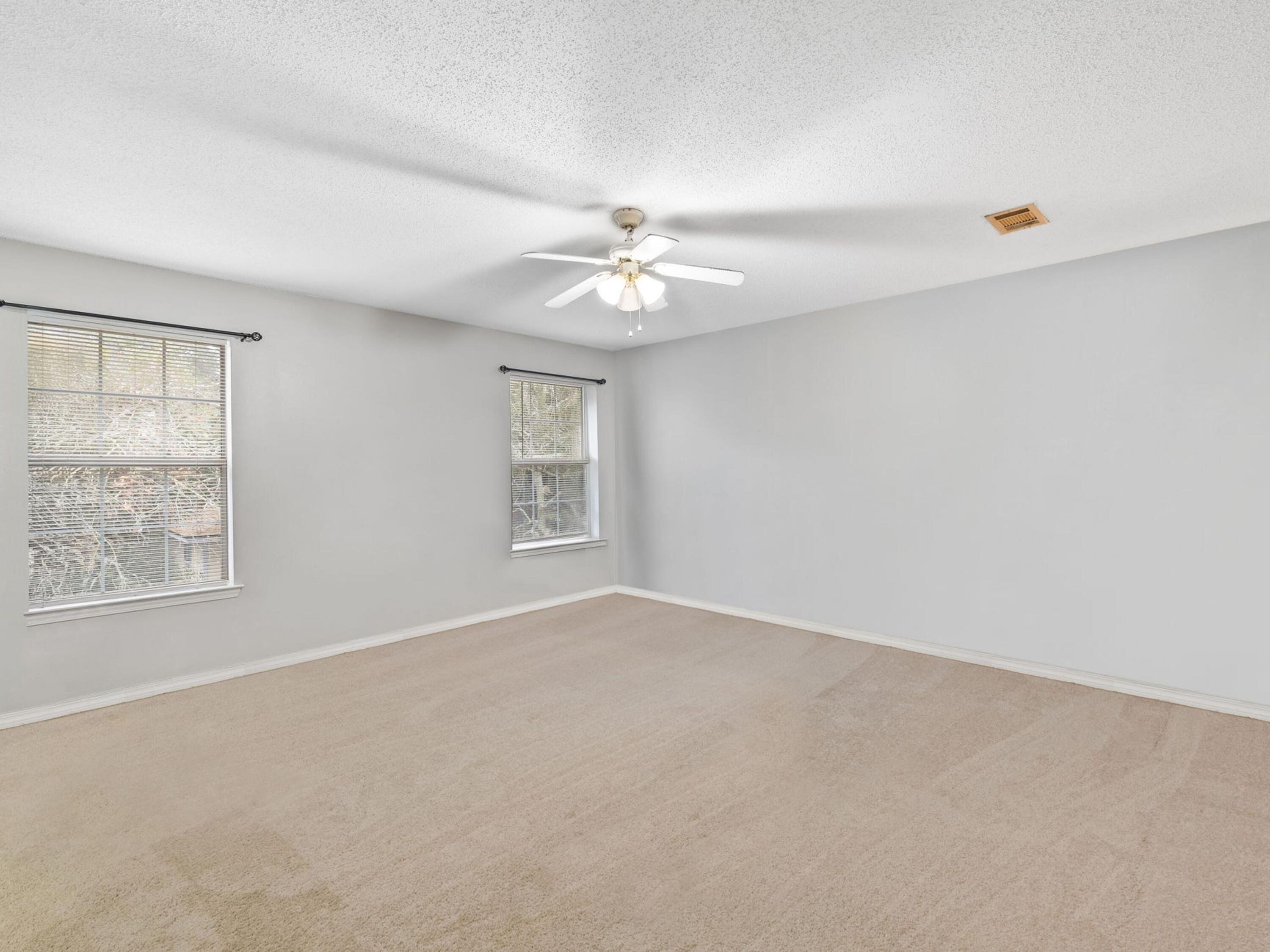 477 Keystone Road Mary Esther, FL 32569 - Photo 13 of 19 an empty room with windows and ceiling fan