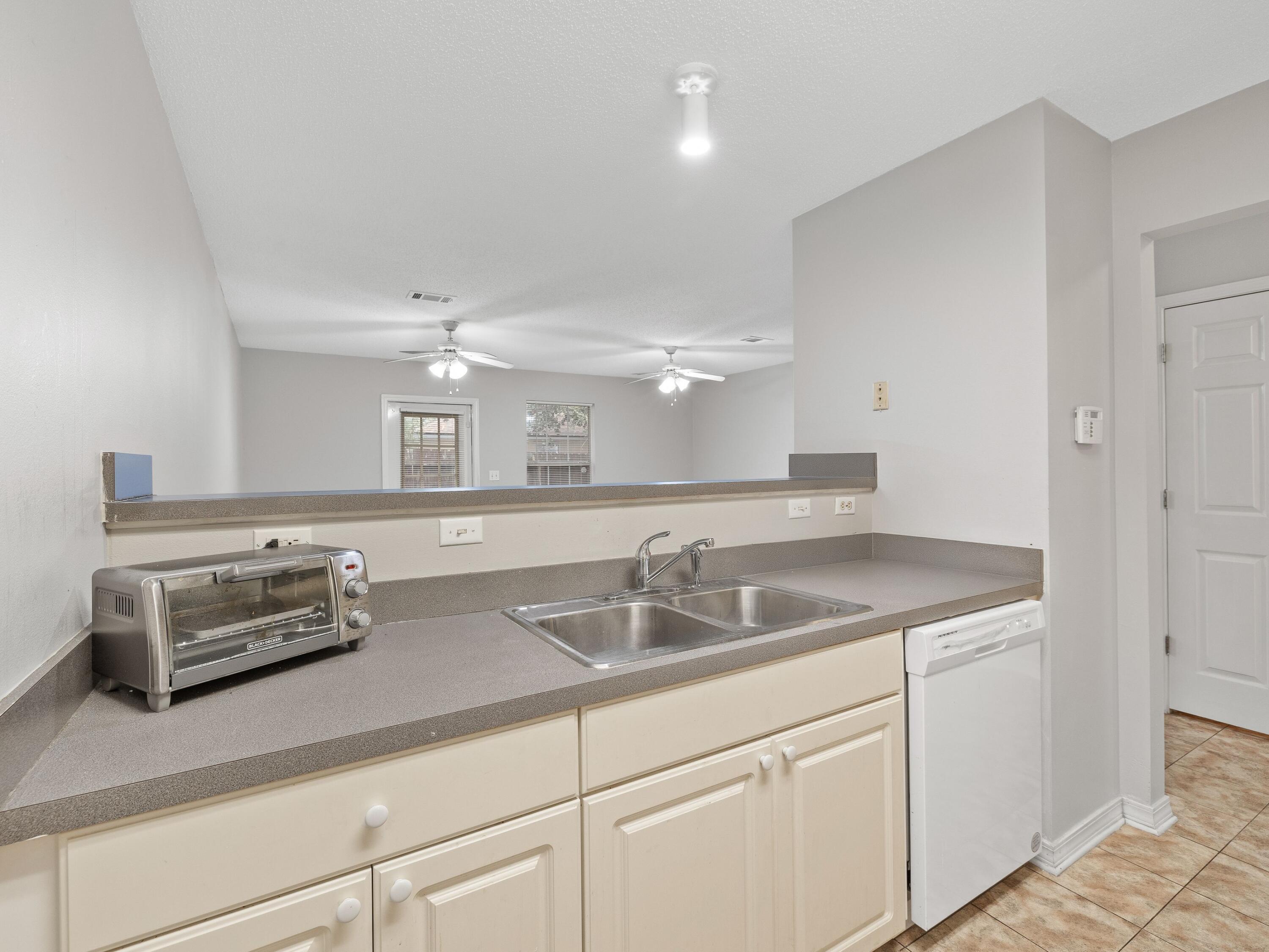 477 Keystone Road Mary Esther, FL 32569 - Photo 4 of 19 a kitchen with stainless steel appliances granite countertop a sink and a white cabinets