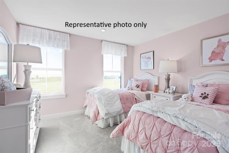 3008 Bramble Hedge Drive, Unit 3272 Indian Trail, NC 28079 - Photo 9 of 13 a bedroom with two beds and a window