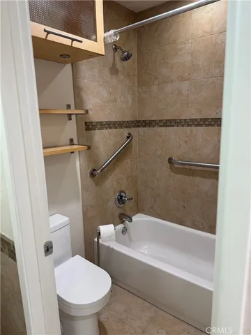 a bathroom with a bathtub and a toilet