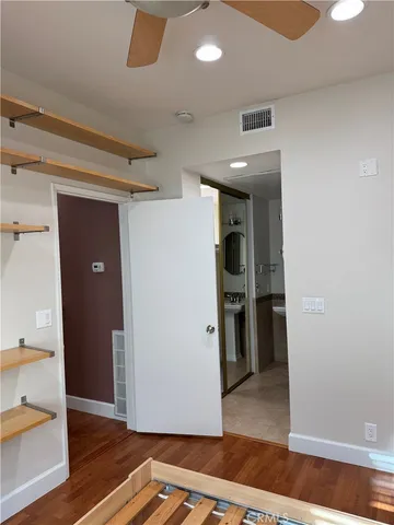 a view of kitchen with wooden floor and cabinets