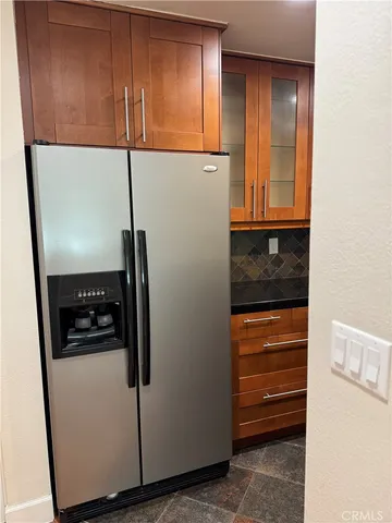 a kitchen with stainless steel appliances granite countertop a refrigerator and a sink