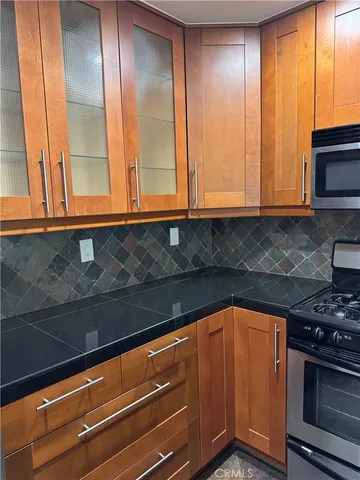 a kitchen with a sink a stove and cabinets