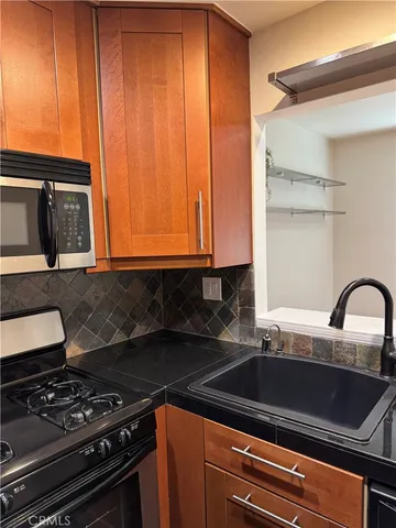a close view of a stove a sink and dishwasher