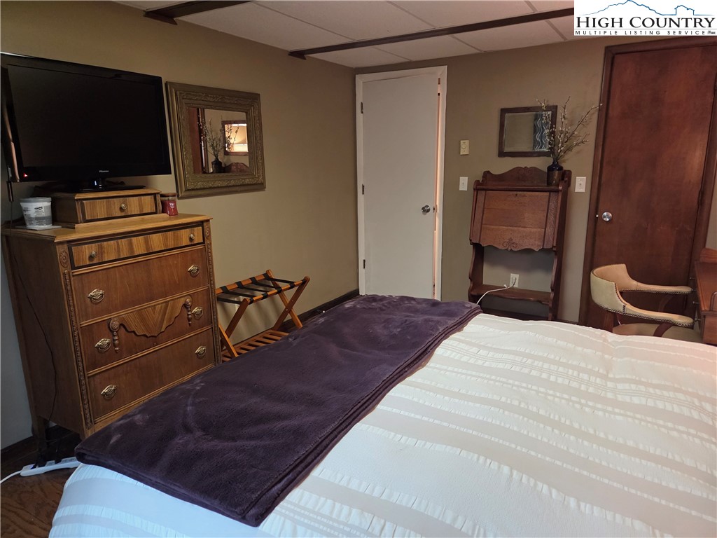 24 Laurel Ridge, Unit C Banner Elk, NC 28604 - Photo 11 of 14 a bedroom with a bed and a flat screen tv
