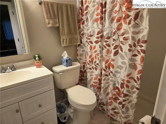 a white toilet sitting next to a bathroom sink