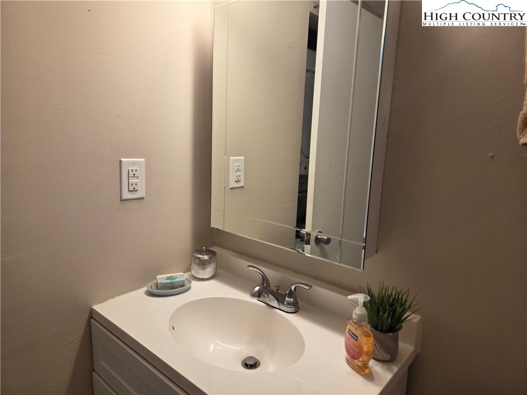 24 Laurel Ridge, Unit C Banner Elk, NC 28604 - Photo 8 of 14 a bathroom with a sink and a mirror