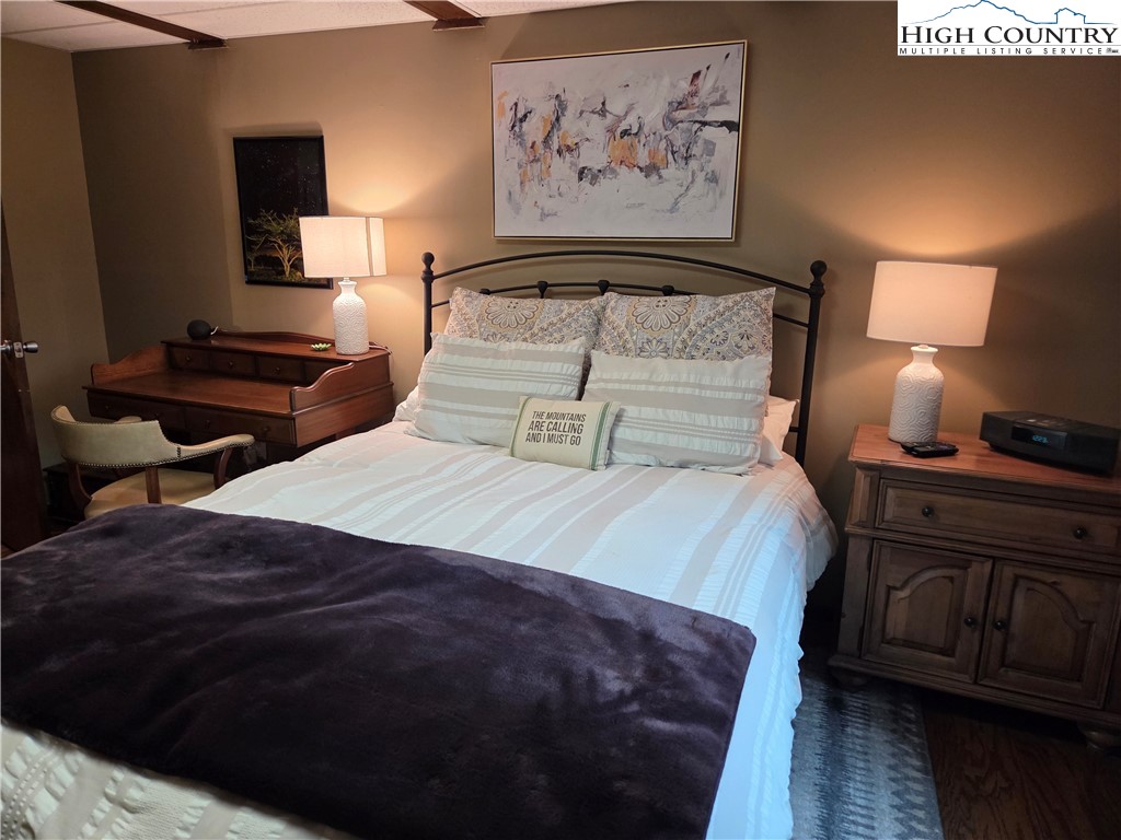 24 Laurel Ridge, Unit C Banner Elk, NC 28604 - Photo 10 of 14 a bedroom with a bed and wooden floor
