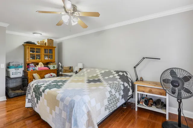 a bedroom with bed and a chandelier