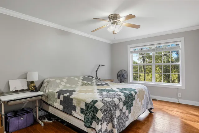 a bedroom with a bed and a chandelier