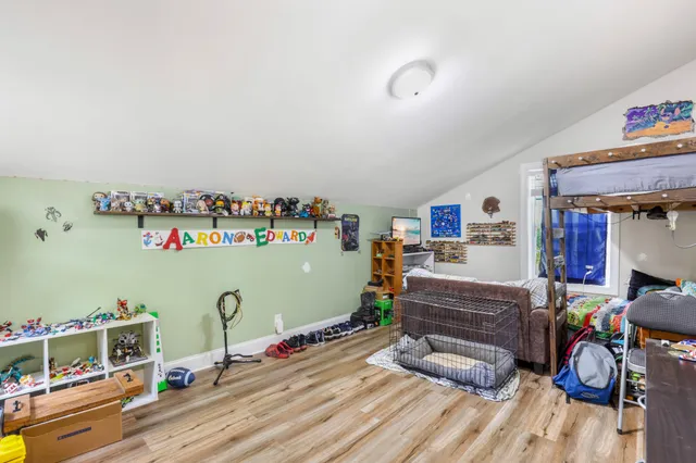 a bedroom with furniture and a wooden floor