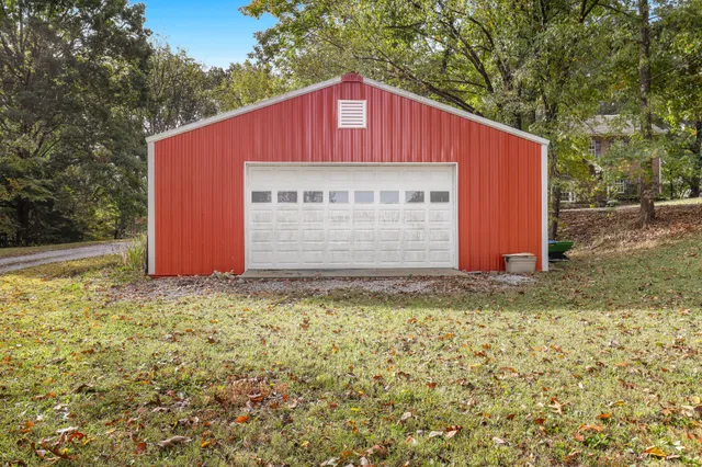 a view of backyard of house with green space