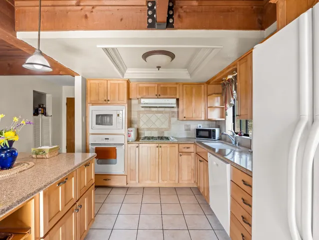a view of a kitchen with furniture and large window