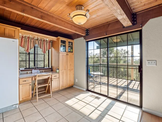 a kitchen with granite countertop a sink a stove and cabinets