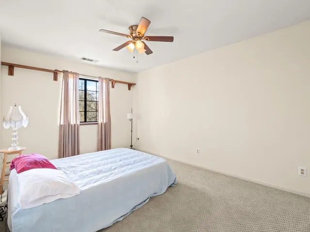 a view of staircase with lots of frames on wall and stairs