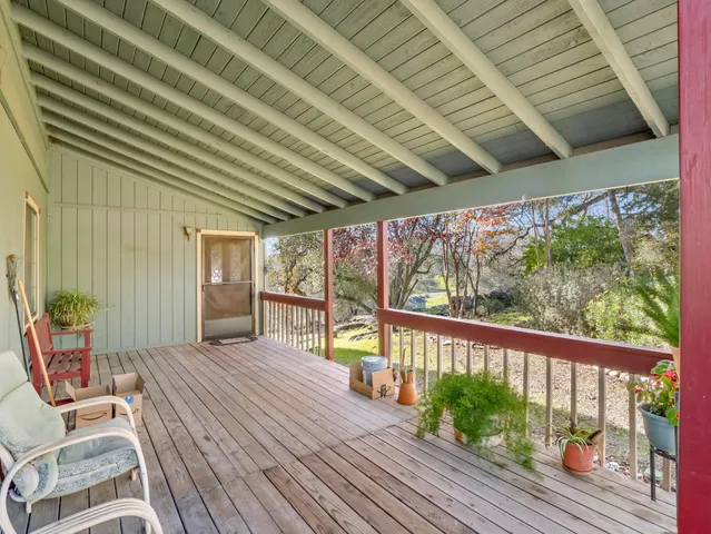 a view of staircase with lots of frames on wall and a chandelier