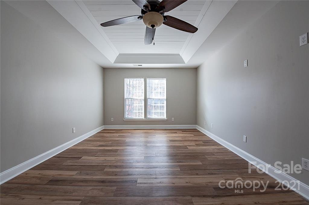 708 Knightswood Road Fort Mill, SC 29708 - Photo 14 of 28 a view of an empty room with window and wooden floor