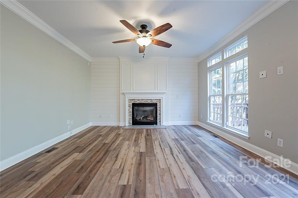 708 Knightswood Road Fort Mill, SC 29708 - Photo 3 of 28 wooden floor in an empty room with a fireplace