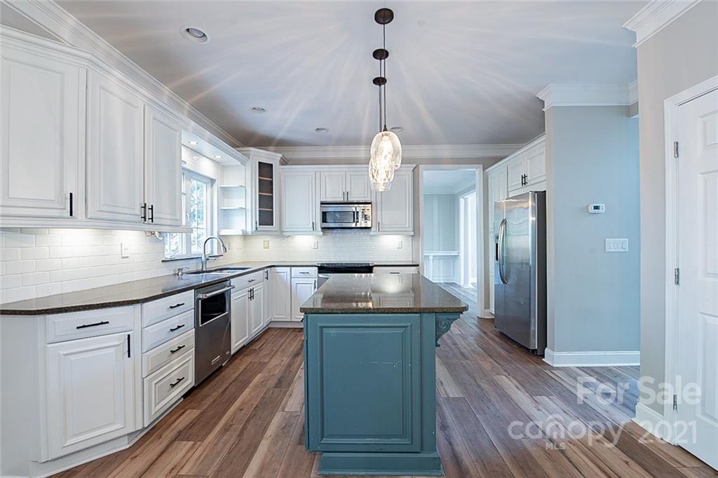 708 Knightswood Road Fort Mill, SC 29708 - Photo 8 of 28 a kitchen with stainless steel appliances granite countertop a sink a stove and a refrigerator