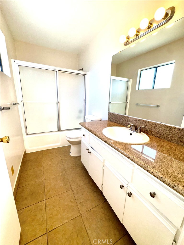 430 East San Jose Avenue, Unit F Burbank, CA 91501 - Photo 15 of 16 a spacious bathroom with a granite countertop sink and a mirror