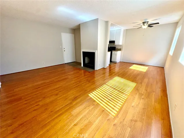 a view of a bedroom with wooden floor and a bathroom