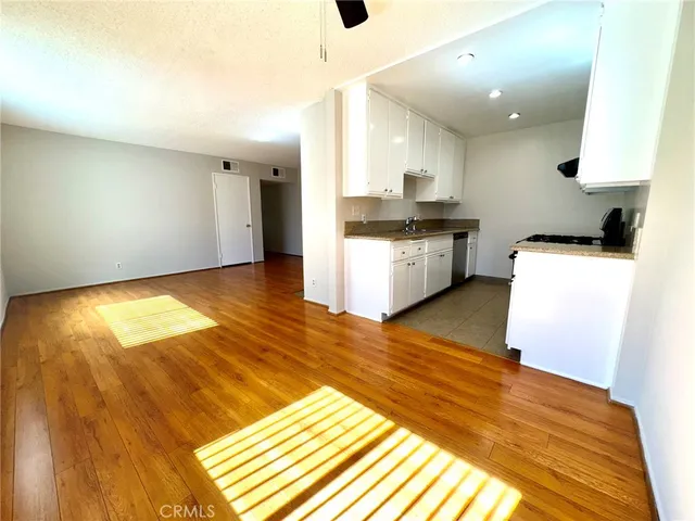 a kitchen with kitchen island white cabinets and black appliances