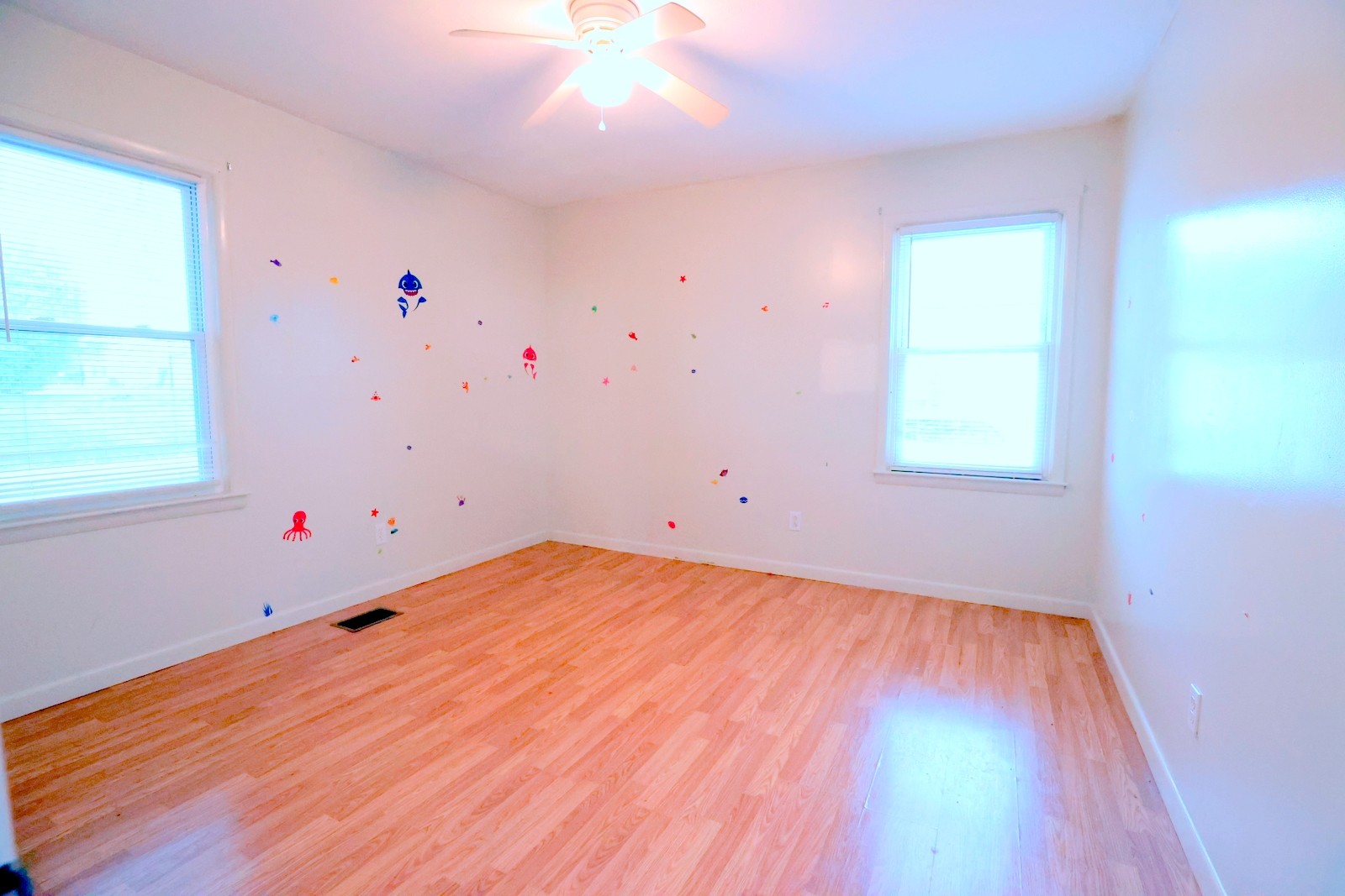 210 Rosenwald Street Trenton, KY 42286 - Photo 12 of 17 an empty room with wooden floor and windows