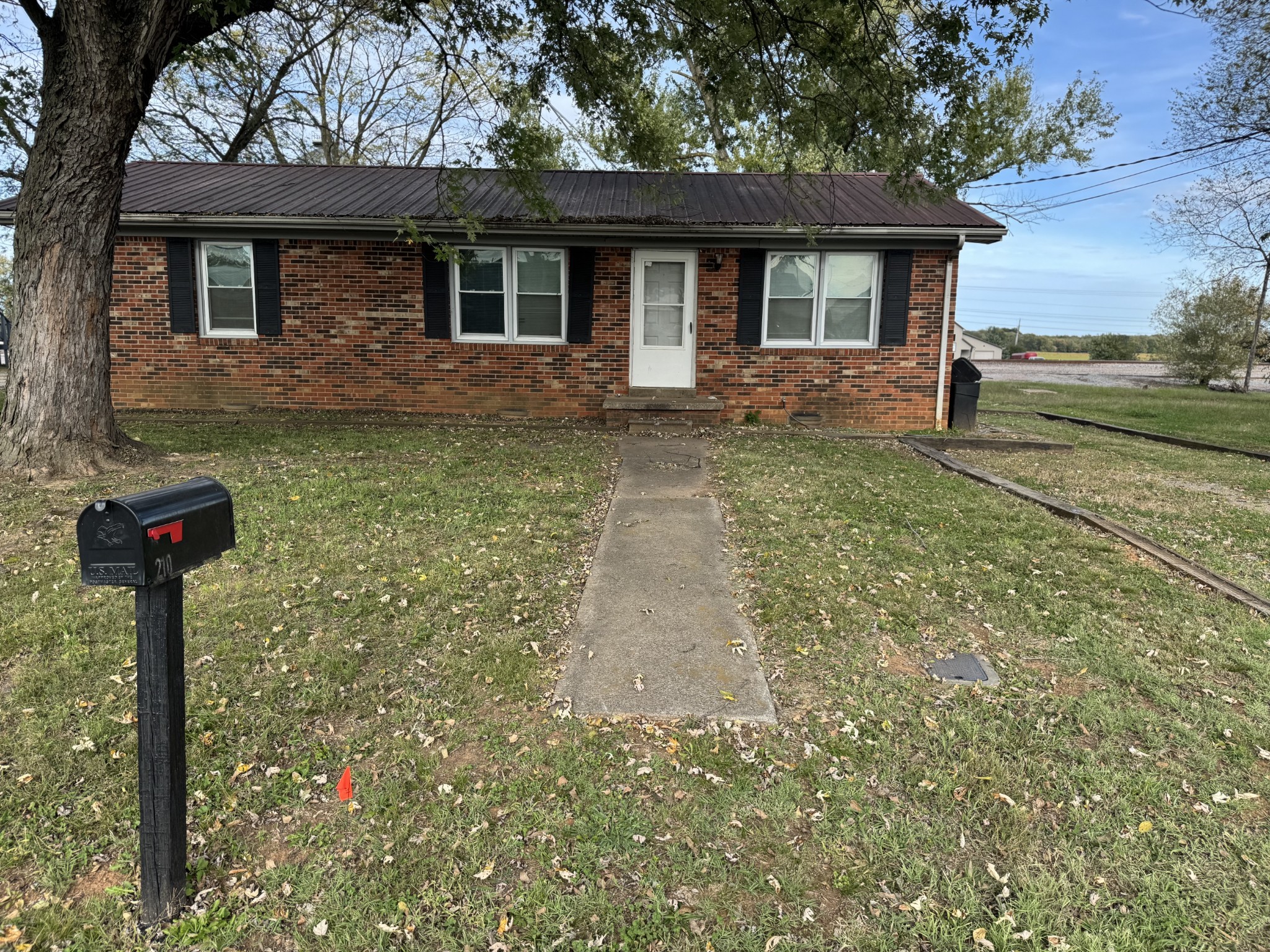 210 Rosenwald Street Trenton, KY 42286 - Photo 3 of 17 a front view of a house with garden