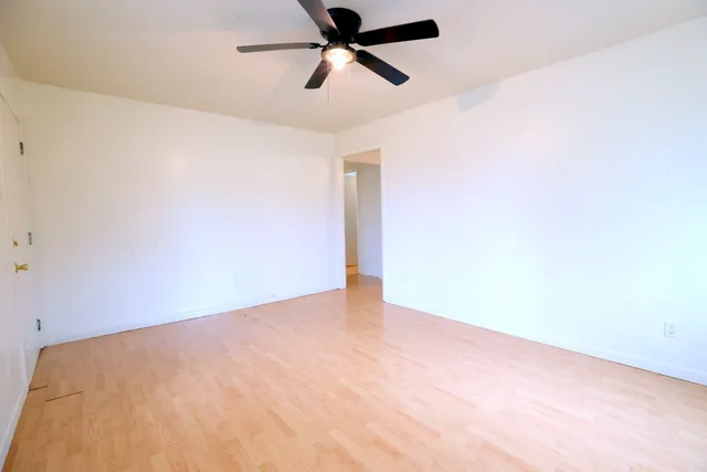 a view of a big room with a ceiling fan
