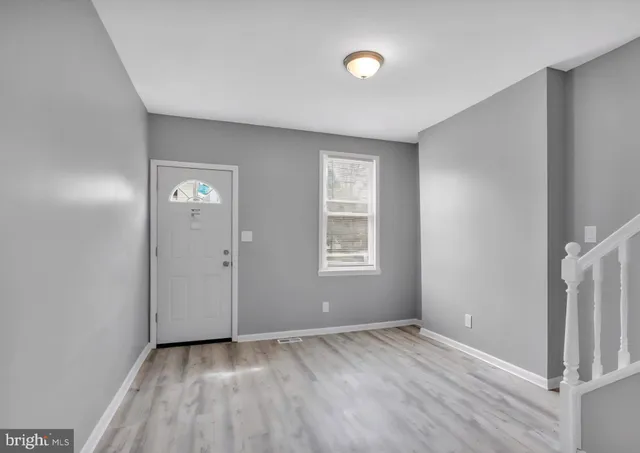 an empty room with windows and closet