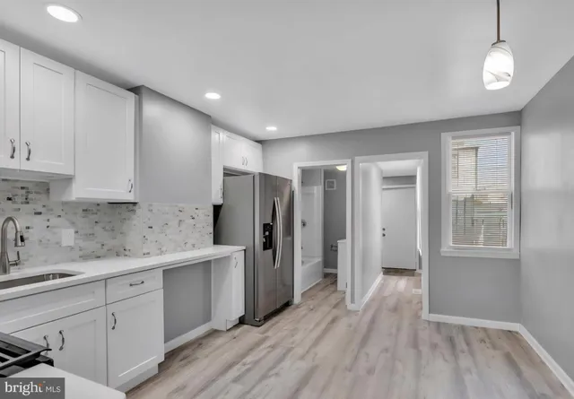 a kitchen with stainless steel appliances granite countertop a refrigerator and a sink