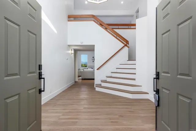 a view of entryway and hall with wooden floor