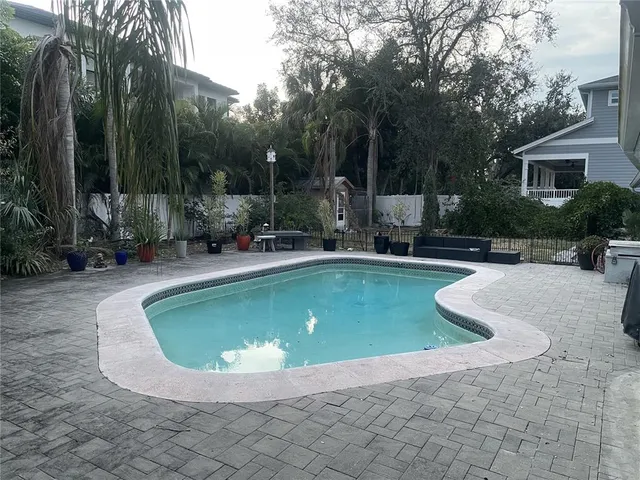 a view of a swimming pool with a patio