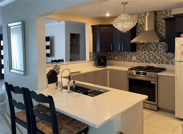a kitchen with a table chairs stove and microwave