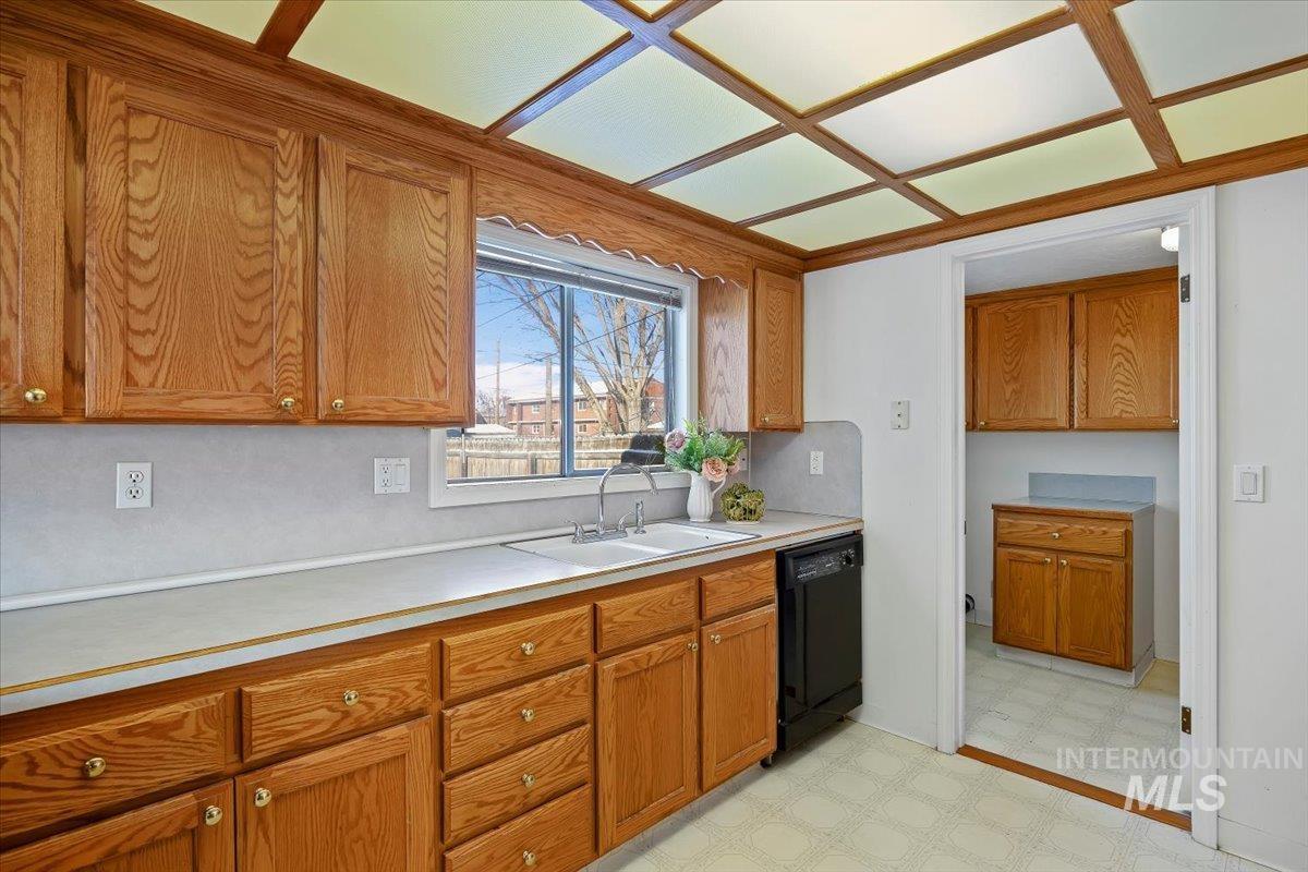 717 E Street Rupert, ID 83350 - Photo 11 of 24 Kitchen featuring light flooring, light countertops, and brown cabinets