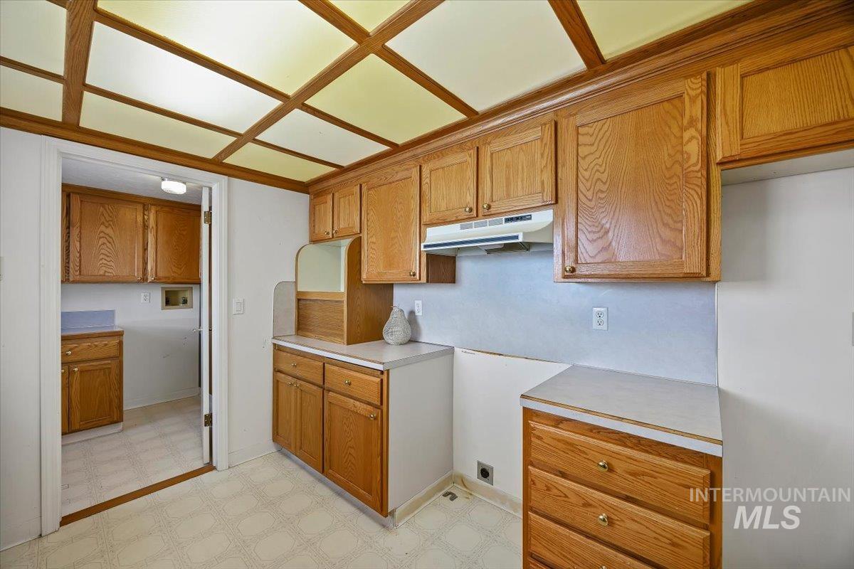 717 E Street Rupert, ID 83350 - Photo 15 of 24 Kitchen with light flooring, light countertops, and brown cabinetry