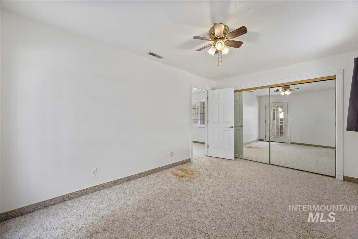 717 E Street Rupert, ID 83350 - Photo 20 of 24 Unfurnished bedroom with carpet floors, a ceiling fan, and a closet